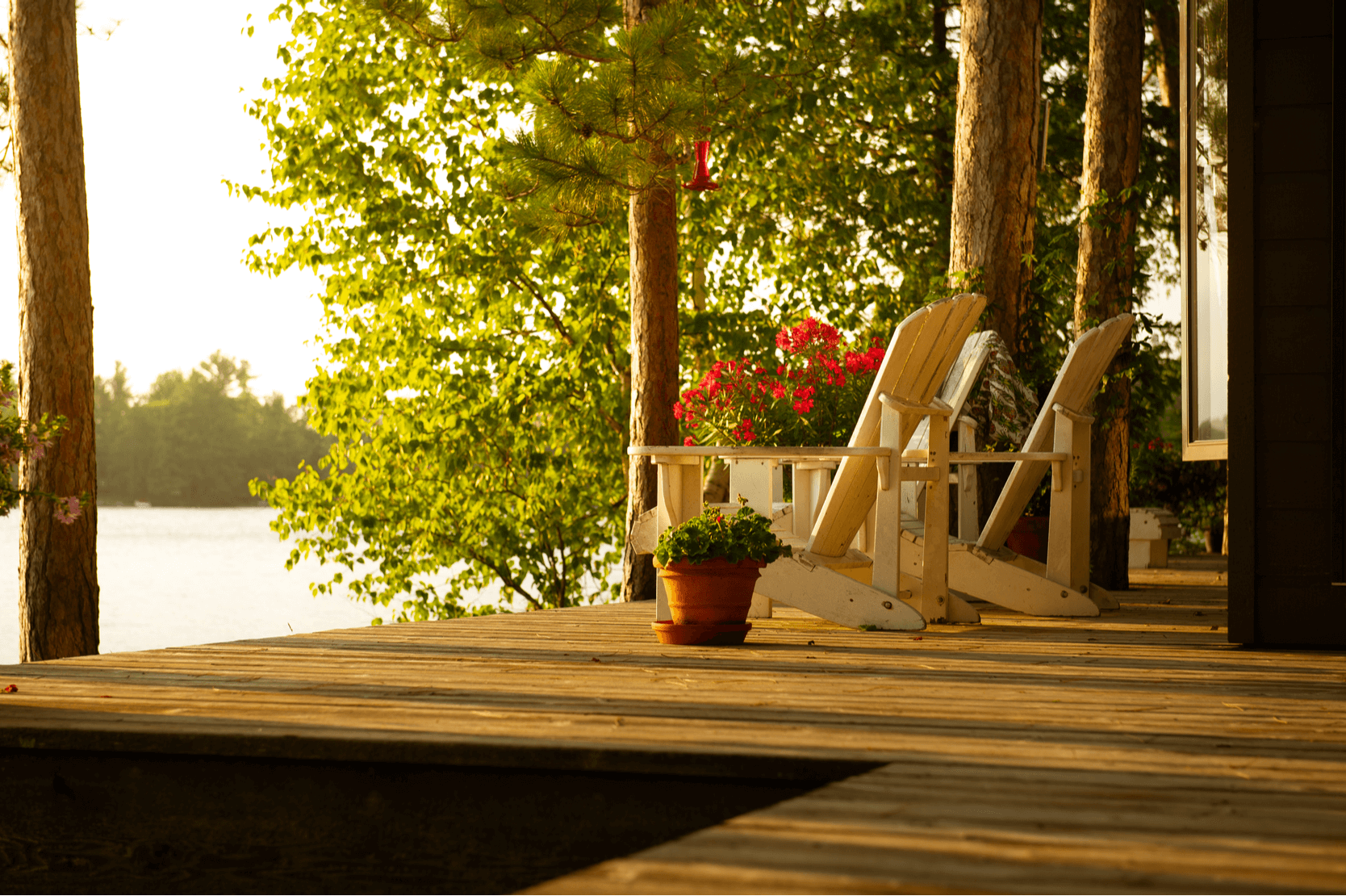 Muskoka chairs on a dock overlooking Muskoka Lake